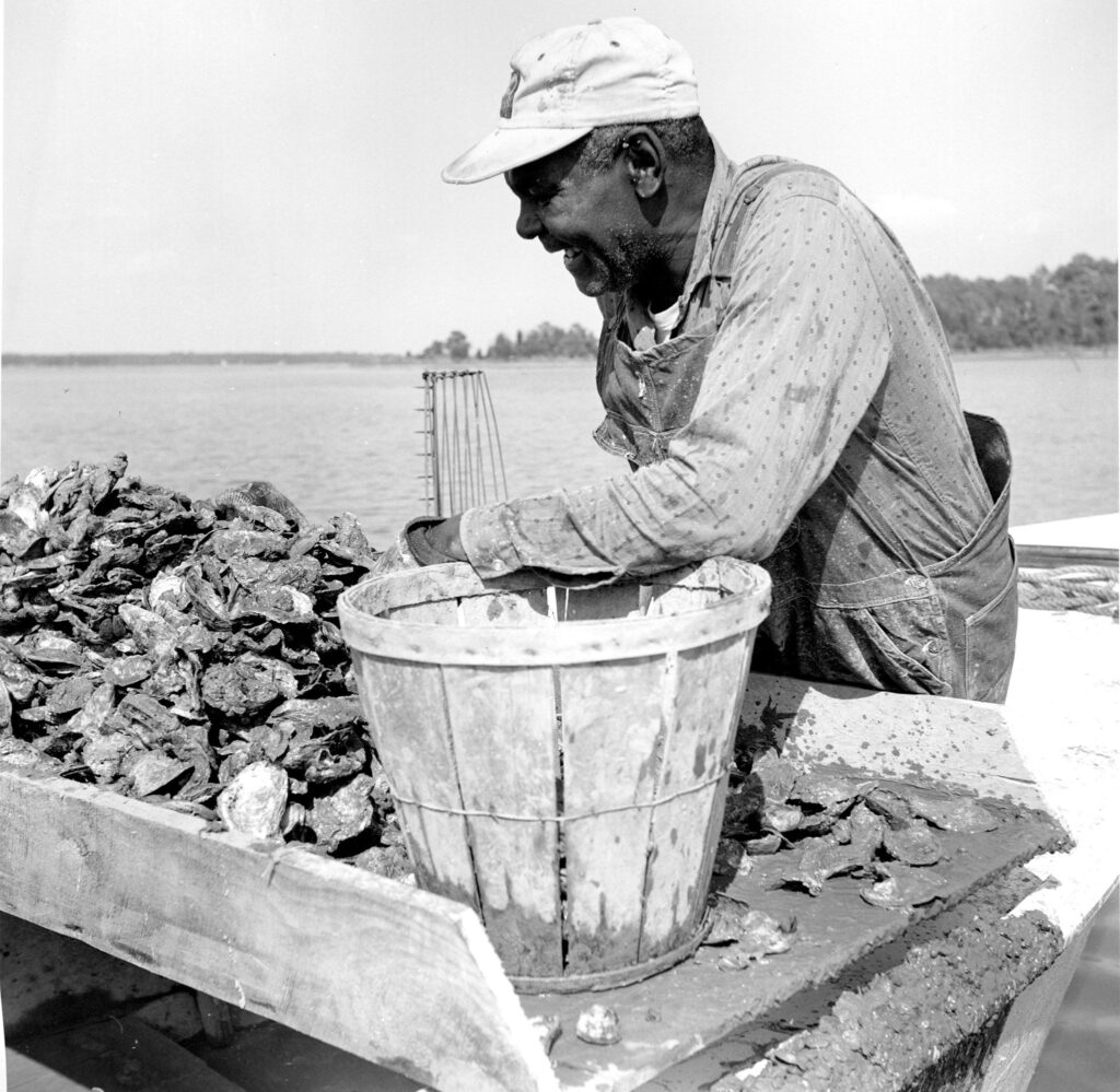 African American with a bucket of crabs.