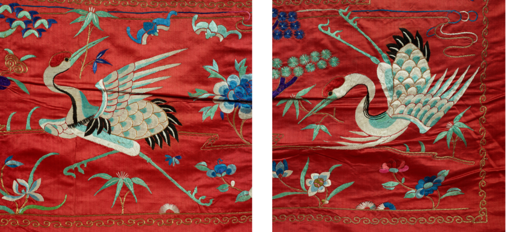 On the tapestry, two white and blue cranes spread their wings, each carrying a flower in its beak.